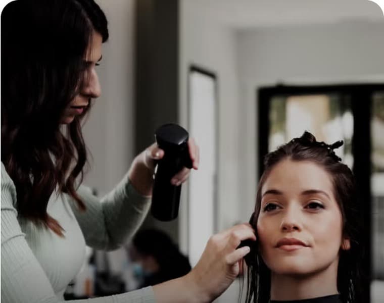 Beauty professional in a polished salon